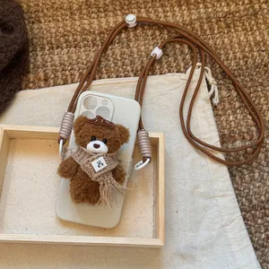 Close-up detail of cute brown plush bear pendant and durable nylon crossbody lanyard strap