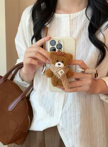 Exquisite plush bear pendant with nylon rope strap shown as a phone accessory