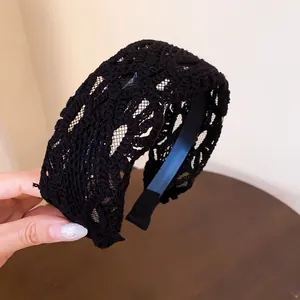 Detailed view of a black vintage lace hollow wide headband with exquisite floral pattern