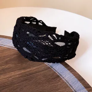 Detail shot of black French vintage wide lace hollow out headband for women