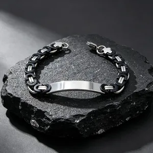 Macro view of a masculine Byzantine chain bracelet with a polished silver engravable plate