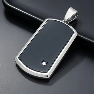 Detailed view of a sleek black dog tag pendant with a single sparkling cubic zirconia