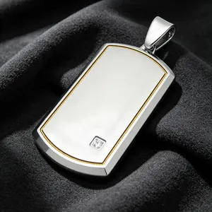 Macro detail of silver titanium steel dog tag pendant with gold border and square diamond.