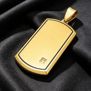 Close-up view of a gold titanium steel dog tag pendant with rhinestone detail.