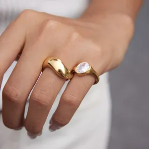 Close-up detail of a high-end gold titanium steel ring set with oval zircon and blob design