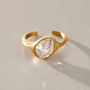 Macro view of a gold titanium steel ring with a large oval zircon stone in sunlight