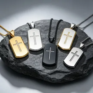 Detailed view of rhinestone cross dog tag pendants in multiple titanium steel finishes.
