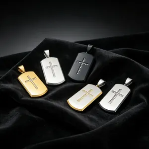 Close-up of diamond-set cross dog tag pendants in various metallic finishes