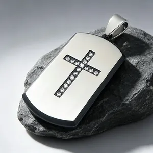 Close-up of titanium steel dog tag pendant with sparkling diamond-encrusted cross detail