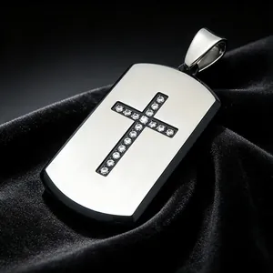 Close-up of titanium steel dog tag pendant with sparkling diamond cross on black velvet.