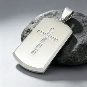 Detailed macro view of a silver stainless steel dog tag pendant with diamond cross inlay