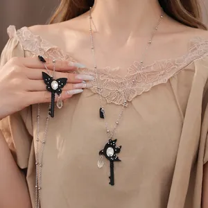 Elegant butterfly and swallow key long necklace featuring glass teardrop crystal pendant