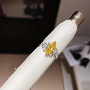 Close-up of a marquise-cut yellow zircon ring on a white leather display tool