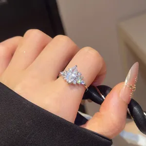 Close-up of marquise-cut cubic zirconia ring on finger, elegant and luxurious design.