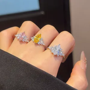 Detail view of marquise-cut zircon open rings in pink yellow and clear stone finishes