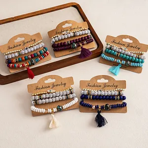 Set of four bohemian beaded bracelets featuring Hamsa hand charms and decorative tassels