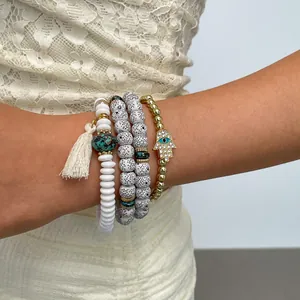 Close-up of 4-piece Hamsa hand and evil eye beaded bracelet set with tassel