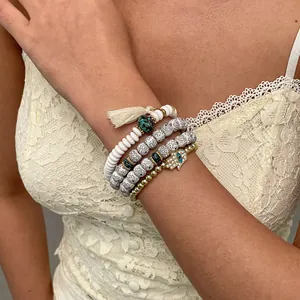 Close-up of four-piece beaded bracelet set featuring Hamsa hand and dalmatian jasper beads