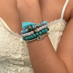 Detail view of 4pcs bohemian beaded bracelets set with Hamsa hand and turquoise beads.