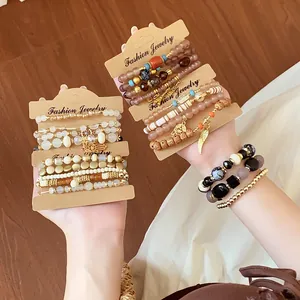 Detail of Bohemian multi-layer beaded bracelet sets with charms and Hamsa hand