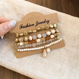 Detailed view of stylish multi-strand beaded bracelet set displayed on a kraft paper card