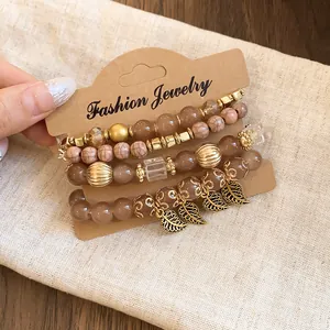 Detail view of a 4-piece brown and gold beaded bracelet set on display card