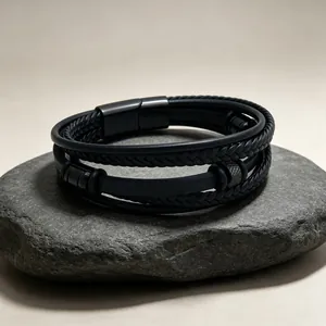 Detail eines dreilagigen geflochtenen schwarzen Lederarmbands mit Magnetverschluss