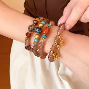 Close-up of bohemian style acrylic beaded bracelet set with Eiffel Tower charm