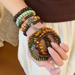 Detailed view of Bohemian multilayered beaded bracelets with ethnic charms
