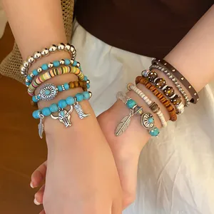 Detail shot showing stacked Bohemian beaded bracelets with turquoise and vintage charms
