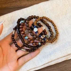 Close-up of bohemian multilayer beaded bracelets with wood beads and tree of life charm