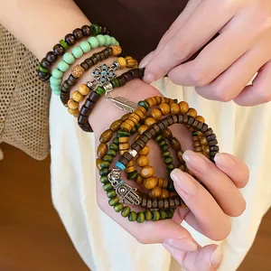 Detailed close-up view of bohemian multilayer wood beaded bracelets with ethnic charms