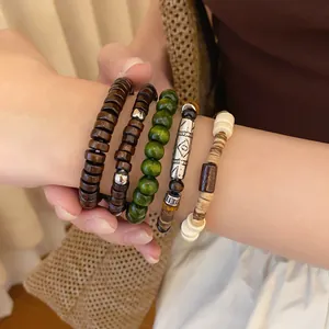 Close-up of bohemian multilayer beaded bracelets featuring wood and tribal metal beads