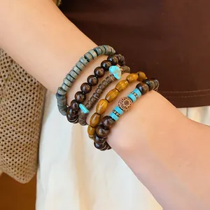 Macro detail of Bohemian multilayer beaded bracelet set with ethnic wooden beads