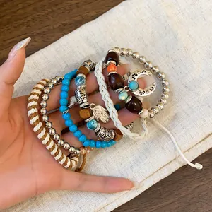 Bohemian multi-layer beaded bracelet set detail featuring Hamsa hand and crescent moon charms