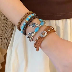 Detail shot of Bohemian layered bracelet set with beads and vintage charms on wrist