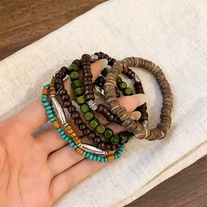 Detailed view of bohemian multi-layer beaded bracelets with ethnic wood and turquoise accents