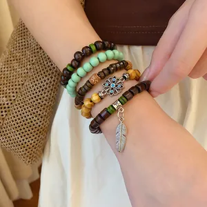 Stacked bohemian multi-layer beaded bracelet set with silver leaf charm on wrist