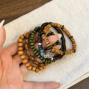 Bohemian multi-layer wooden bead bracelet set with ethnic Hamsa hand charm detail