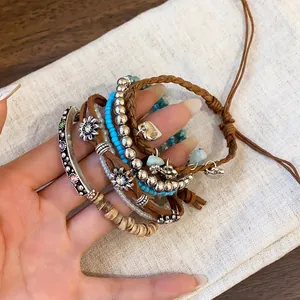 Close-up detail of Bohemian multilayer beaded bracelet set with charms