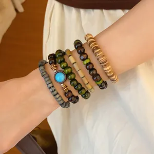 Close-up detail of bohemian multilayer beaded stacking bracelets on a person's wrist