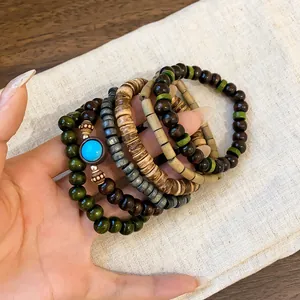 Detail of Bohemian multilayer beaded bracelet set with wood beads and turquoise accent