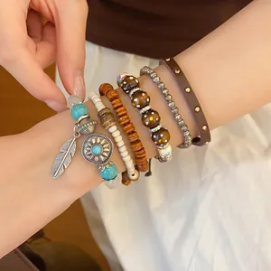 Close-up of bohemian multilayer beaded bracelet set with turquoise charms on wrist