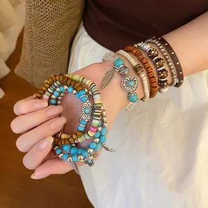 Detailed view of bohemian multi-layer beaded bracelet set with ethnic charms.