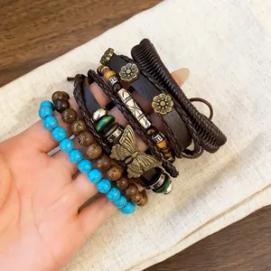 Close-up of Bohemian multi-layer bracelet set with turquoise beads and butterfly charm