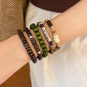 Close-up of Bohemian multilayer beaded bracelet set with wooden and metal accents