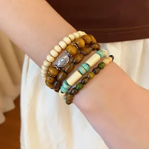 Detailed close-up of Bohemian layered beaded bracelet set worn on a female wrist.