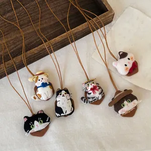 Detailweergave van zes handgemaakte geborduurde kattenkettingen in verschillende designs