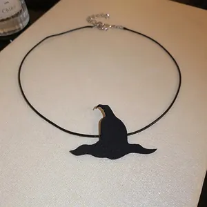 Macro detail view of Halloween black witch hat pendant on adjustable cord choker