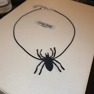 Detailed macro view of a black spider pendant necklace for Halloween costume party wear
